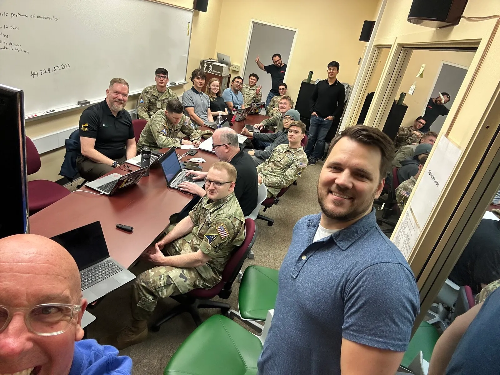 Full classroom of military students participating in hands-on satellite security training